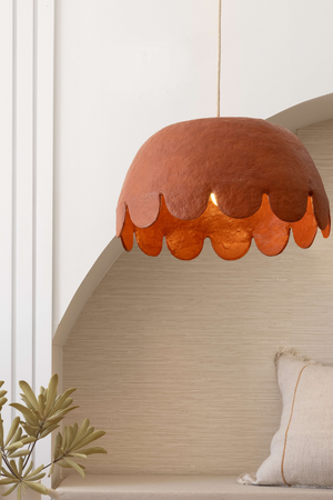 Oversize Clay coloured pendant light hanging in living room