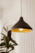 Charcoal sustainable pendant light hanging above a hallway console