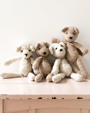 Group of handmade teddy bears sit on toy chest